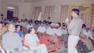 A doctor delivers a talk on maintaining good oral hygiene to the teachers at CDC