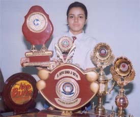 Preeti Lamba, a Plus Two student of Kundan Vidya Mandir, with her trophies and mementoes
