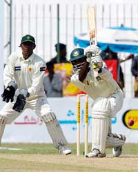 Bangladesh batsman Habibul Bashar drives Pakistani leg-spinner Danish Kanaria 