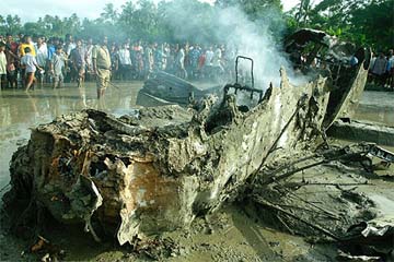 Smoke emits from the Cessna aircraft that crashed at Sethpur village, near Kolkata