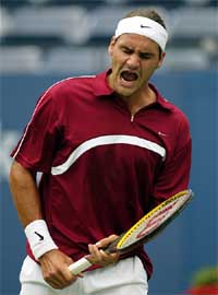 Roger Federer of Switzerland reacts during his match against Jose Acasuso of Argentina