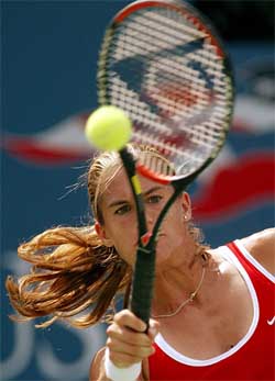 Amelie Mauresmo of France hits a return to compatriot Stephanie Cohen-Aloro