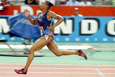 Kelli White of the US sprints to victory in the Women's 200m final at the World Athletics championships