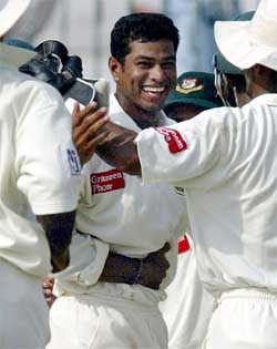 Bangladeshi bowler Alok Kapali is congratulated by teammates 