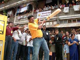 Cricket legend Kapil Dev plays cricket at a narrow lane in Mumbai 