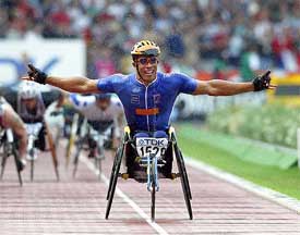 France's Joel Jeannot celebrates after winning the 1500m wheelchair race 