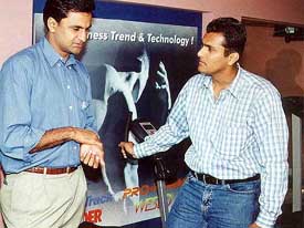 Fast bowler Javagal Srinath and former hockey goalkeeper Ashish Ballal have a conversation 
