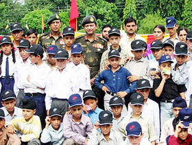 Lieut-Gen Hari Prasad, GOC-in-C, Northern Command, with a group of 100 terrorism-affected children who have been adopted by the Army for their studies