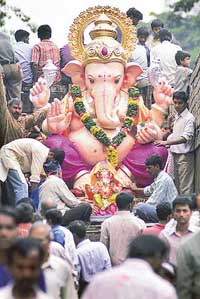 Devotees carry an idol of Ganesh in Mumbai on Sunday