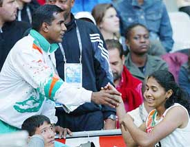 Anju Bobby George meets her husband-cum-coach after winning the bronze medal