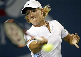 Justine Henin-Hardenne of Belgium hits a return to Saori Obata of Japan 