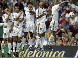 Real Madrid players Esteban Cambiasso, Zinedine Zidane, Luis Figo, Ronaldo and David Beckham try to block a Real Betis free kick