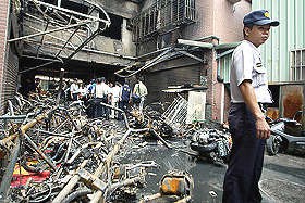 A residential building on the outskirts of Taipei, which was charred by a fire that killed 13 persons and injured 68 on Sunday