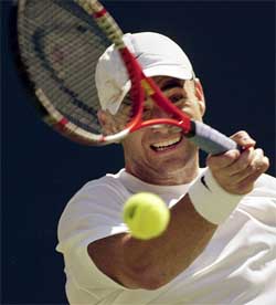 Andre Agassi of the US hits a return to Yevgeny Kafelnikov of Russia