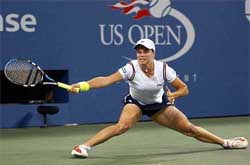 Kim Clijsters of Belgium streches for a return during her match against Meghann Shaughnessy of the US
