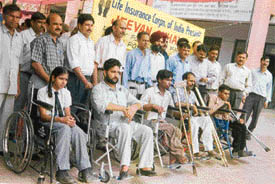 Officials of the LIC with the physically challenged who were given wheelchairs