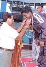 Kailash Nath of CRPF is being presented the gold medal for winning the 400m event in the 52nd All-India Police Aquatic and Cross Country Championships at the Talkatora swimming pool.