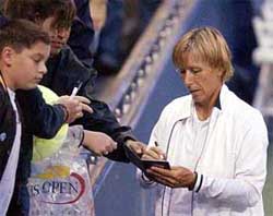 Martina Navratilova signs autographs prior to her doubles match with partner Svetlana Kuznetsova 