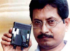 Young scientist Ramendralal Mukherjee shows a Micro Microscope