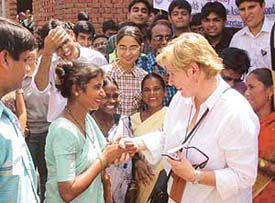 Mrs Virginia Goodings, Head of the Human Resources Commonwealth Secretariat, London, on a visit to a city slum