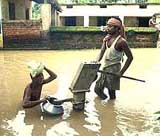 Villagers collect drinking water at the flooded Masai block in Orissa 