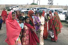 Family members of fishermen wait at Okha port on Saturday for the return of 269 fishermen released from Pakistani prisons