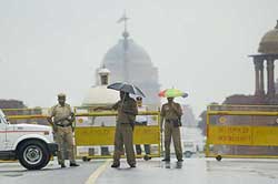 Delhi Police personnel stand guard at a roadblock near Rashtrapati Bhavan in New Delhi 
