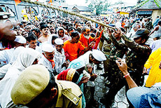 Devotees push through a security cordon as they hope to participate in the last auspicious bath of the Kumbh Mela