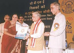 Amity International School Principal Bharti Sharma receiving the CBSE Award from Union HRD Minister Dr Murli Manohar Joshi