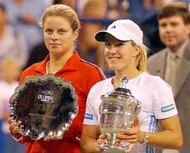 Justin Henin-Hardenne of Belgium poses with the winners trophy along with compatriot and runner-up Kim Clijsters 