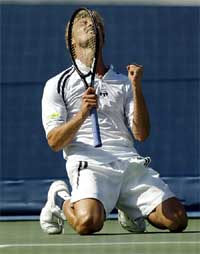 Juan Carlos Ferrero of Spain celebrates his win over Andre Agassi of the US