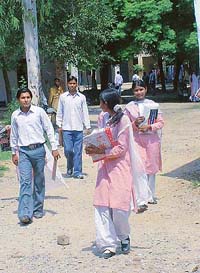 Students of Government Senior Secondary School, Gobind Nagar, come out of the campus after taking their mid-term examination in Ludhiana on Monday