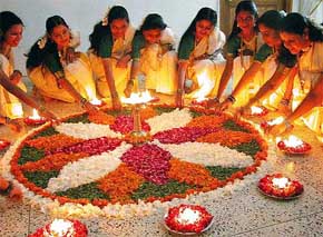 Keralite women decorate floral rangoli on the eve of Onam festival in Bhopal