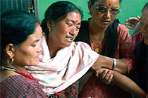 Purna Maya Gurung, mother of bomb blast victim Deepak Gurung, is comforted by relatives and friends in Kathmandu