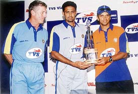 Indian cricket stars Rahul Dravid and Anil Kumble along with their coach John Wright at the launch of TVS Salve Challengers Series Trophy
