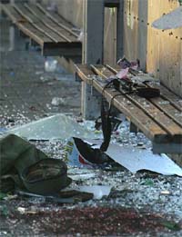 The weapon and uniform of an Israeli soldier lays amid broken glass at the scene of the explosion outside an army base near Tel Aviv