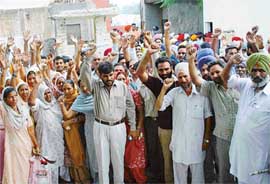 Agitating residents and municipal councillors of the Zirakpur Nagar Panchayat hold a protest
