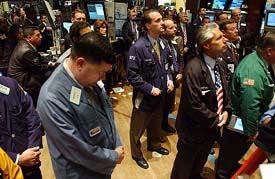 Traders at the New York Stock Exchange pause to observe a moment of silence on Thursday