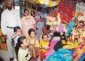 Students of Pearls Nursery School watch a puppet show along with their grandparents