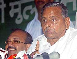 Uttar Pradesh Chief Minister Mulayam Singh Yadav, along with Samajwadi Party leader Amar Singh, addresses a Press conference