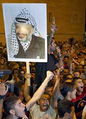 Supporters of Palestinian President Yasser Arafat shout during a rally