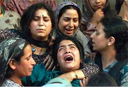 The wailing daughter (centre) of Mohammed Yousaf Parray, alias Kukka Parray, is consoled by relatives