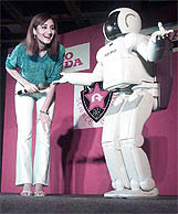 World�s most advanced humanoid robot �Asimo� dances with a girl at the National Science Centre in New Delhi 