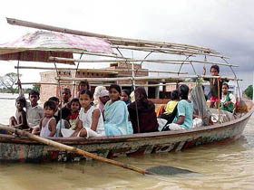People move to safer places on a boat following the flood in Allahabad 
