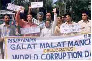 Galat Malat Manch activists hold placards to mark Ravi Sidhu's birthday as World Corruption Day