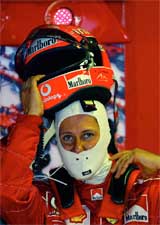 Ferrari's German driver Michael Schumacher takes off his helmet after a practice session 
