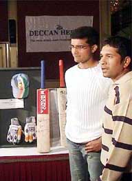 Indian skipper Saurav Ganguly and master blaster Sachin Tendulkar pose with some of the cricket memorabilia parted by them and some top cricketers at an auction 