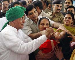 Haryana Chief Minister Om Prakash Chautala administers polio drops to a child in Ambala 