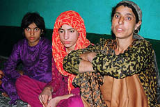 Ameena Bano (extreme right), with her two daughters, tells the tragic story of her life at her home in Chuk Seer village in Pattan. Her husband was killed by assailants on his farm.