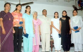 Winners of a Hindi poetry recitation competition at Devki Devi Jain College pose with judges and guests 
